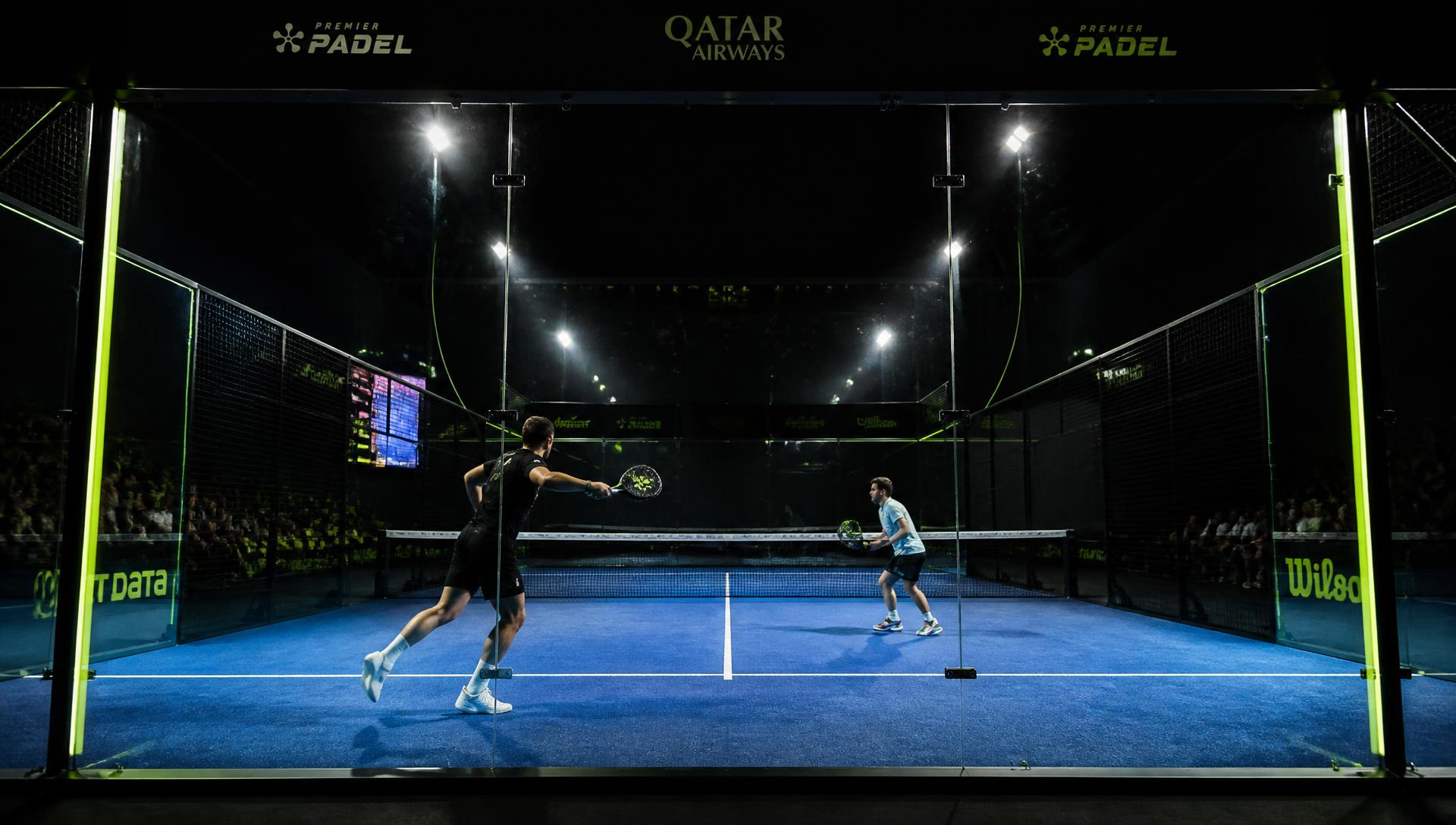 Two players in a rally on an indoor padel court at Top Padel Basildon
